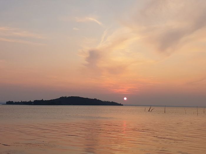 Scenic view of sea against romantic sky at sunset