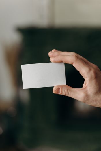 Cropped hand of woman holding blank paper