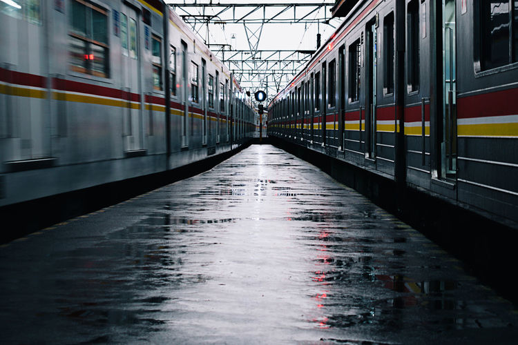 Trains at railroad station during rainy season