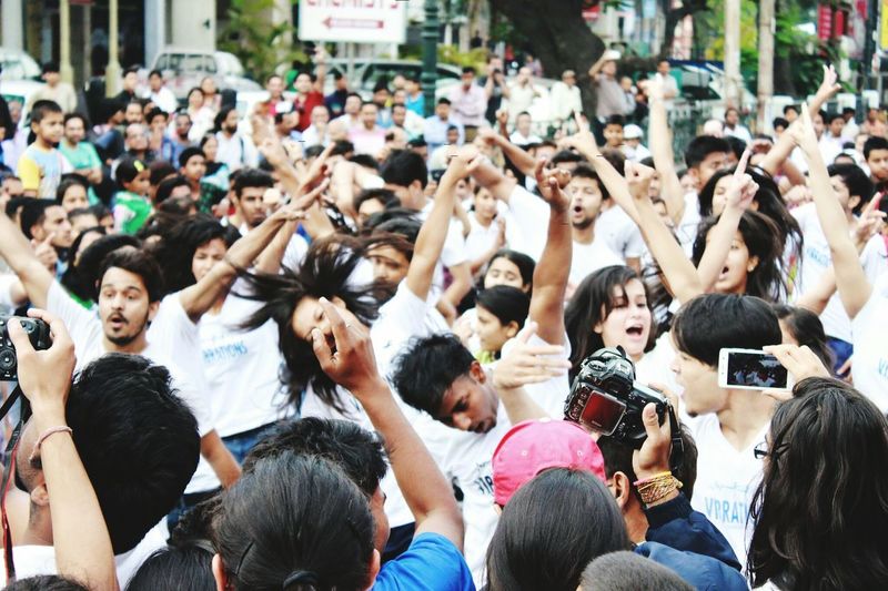 Crowd dancing on street during carnival