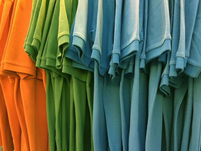 Close-up of multi colored t-shirts hanging for sale