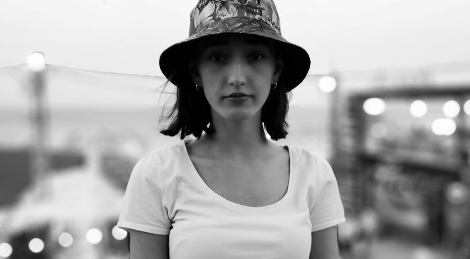 Portrait of girl wearing hat standing outdoors