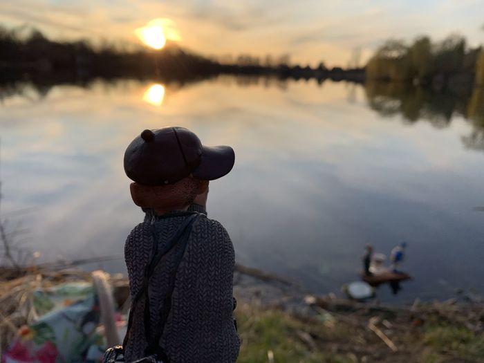 Close-up of doll against lake during sunset