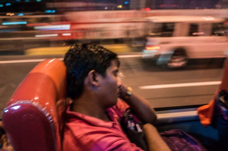 Man in car on road at night