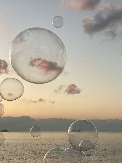 BUBBLES AGAINST SEA DURING SUNSET