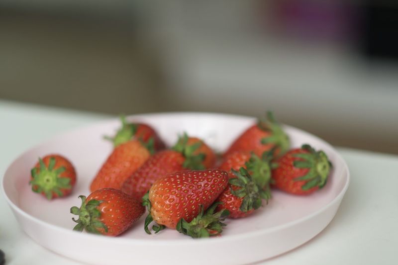 Close-up of strawberries in plate on table
