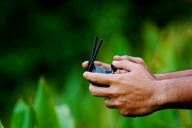Close-up of man holding remote control