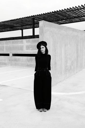 Smiling woman standing against wall