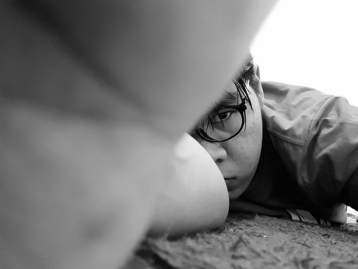 Close-up portrait of boy lying down