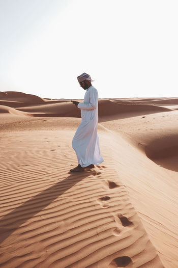 Full length of man on desert against sky