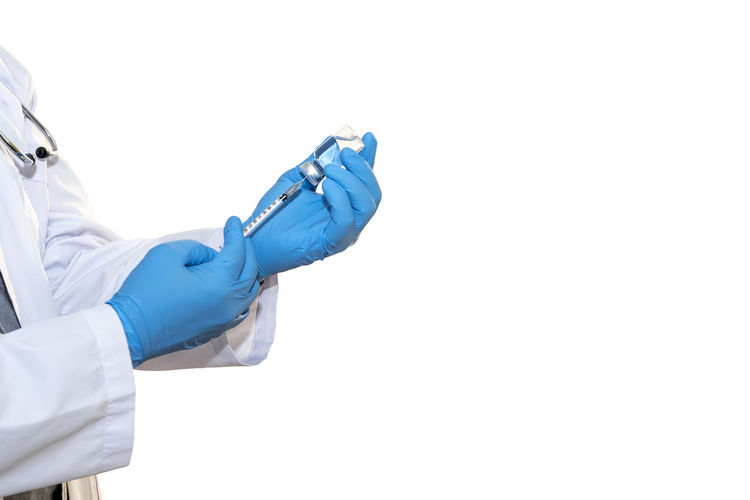 Midsection of person holding umbrella against white background