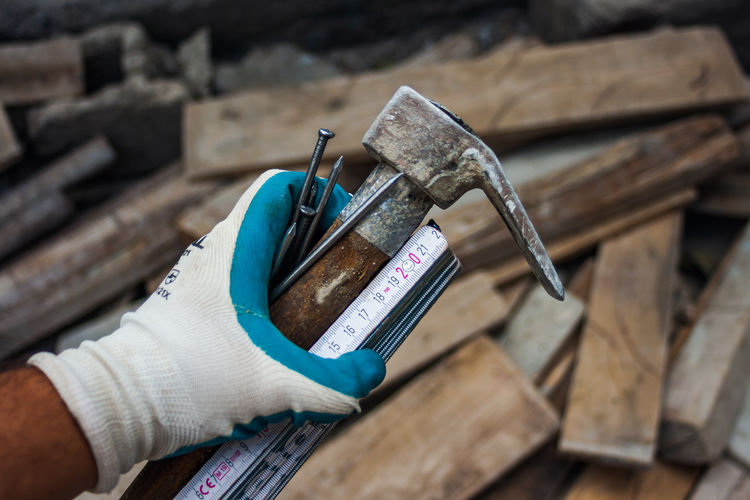 High angle view of person holding camera on wood