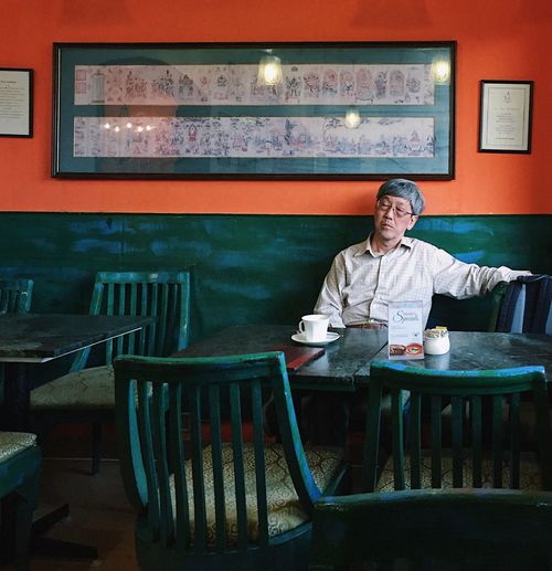 Portrait of man sitting at restaurant table