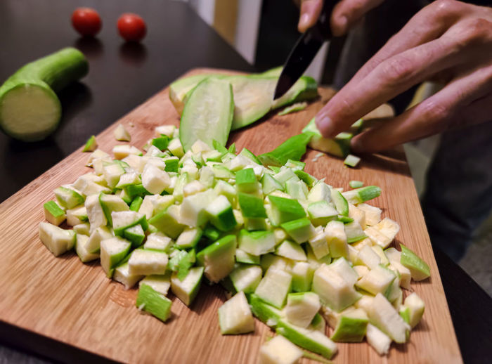 Midsection of chopped vegetables on cutting board