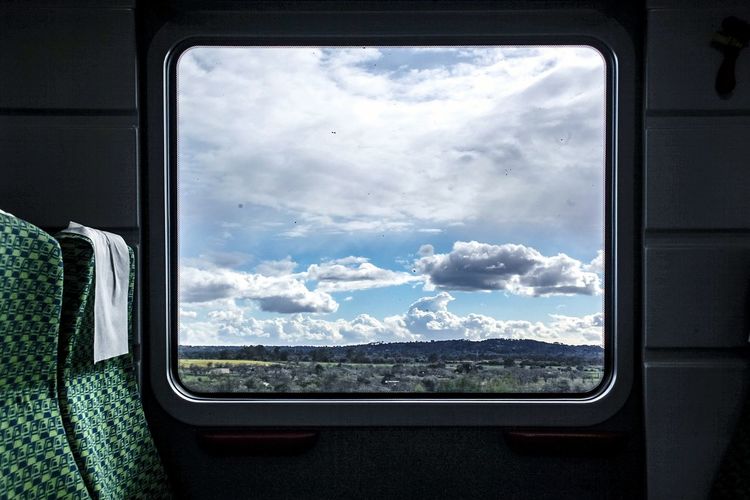 Reflection of sky seen through train window