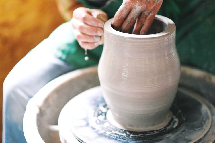 Midsection of craftsperson working at workshop