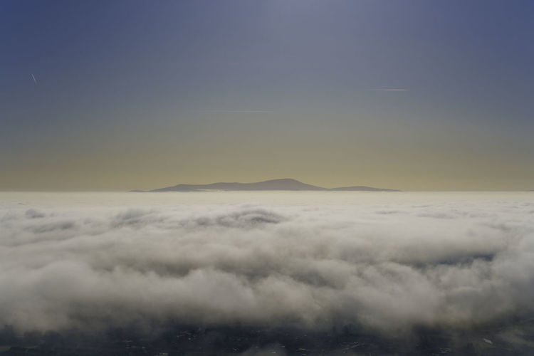 Mount leinster in the distance above a blanket of fog on a sunny day