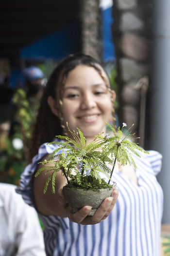 Latin woman with plant in hand