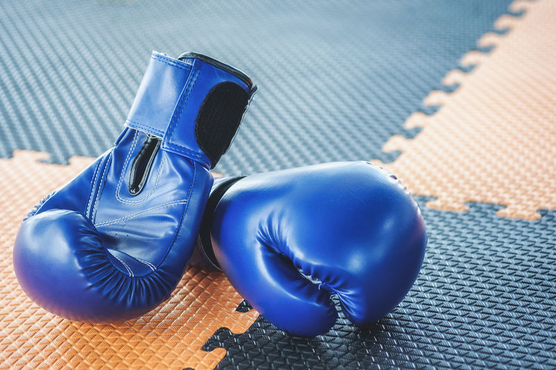 Close-up of boxing gloves on floor