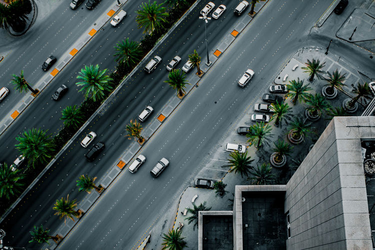 High angle view of cars on road by building in city