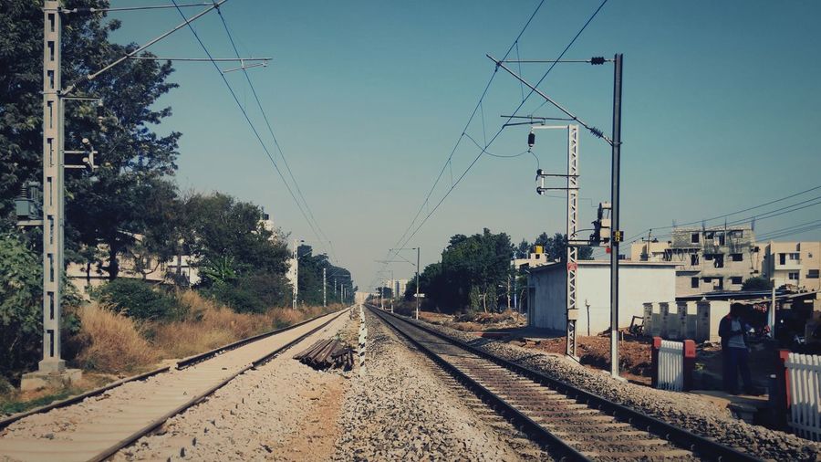 Train on railroad tracks against sky