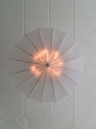 Directly below shot of illuminated umbrella on ceiling
