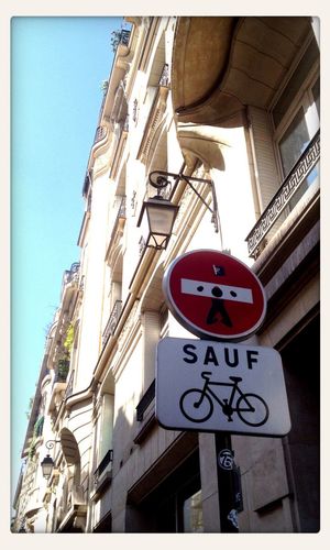 Low angle view of road sign against sky