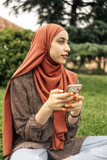 Muslim woman using a phone