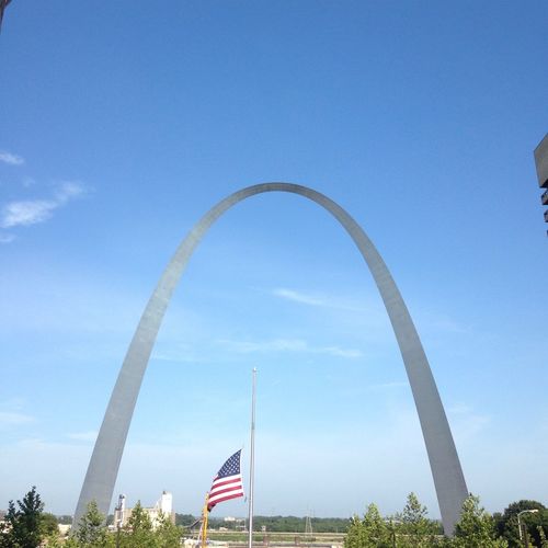 Low angle view of st louis arch against sky on sunny day