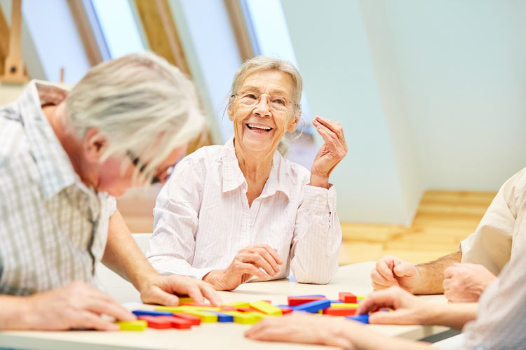 Friends playing with toy blocks in nursing home