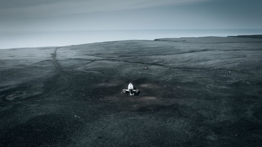 Cinematic aerial view of dc-3 airplane wreckage at black beach, sólheimasandur, iceland.