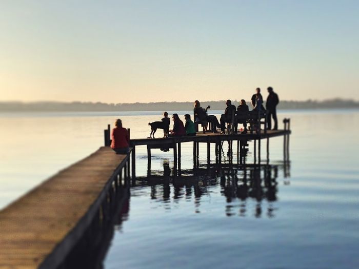 Tourists sitting on pier