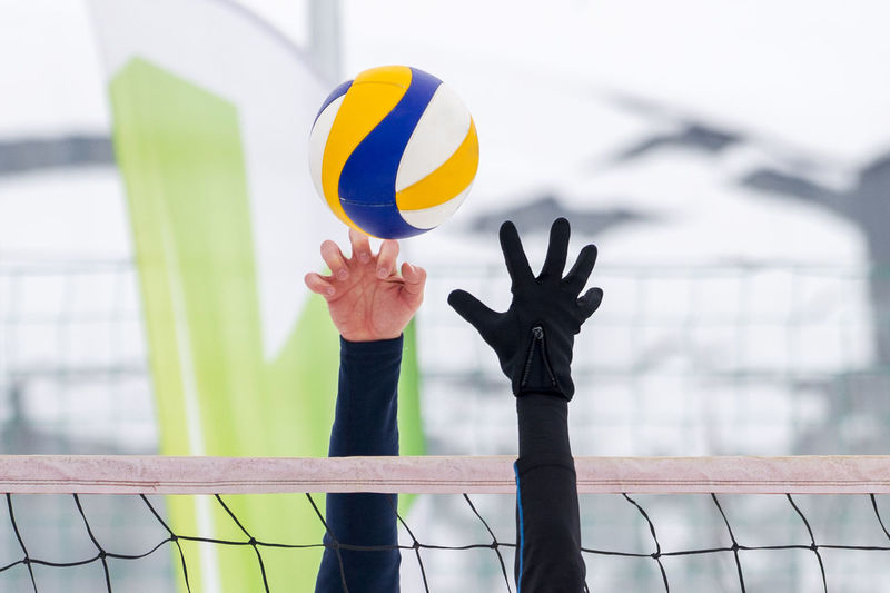 Cropped hands playing volleyball