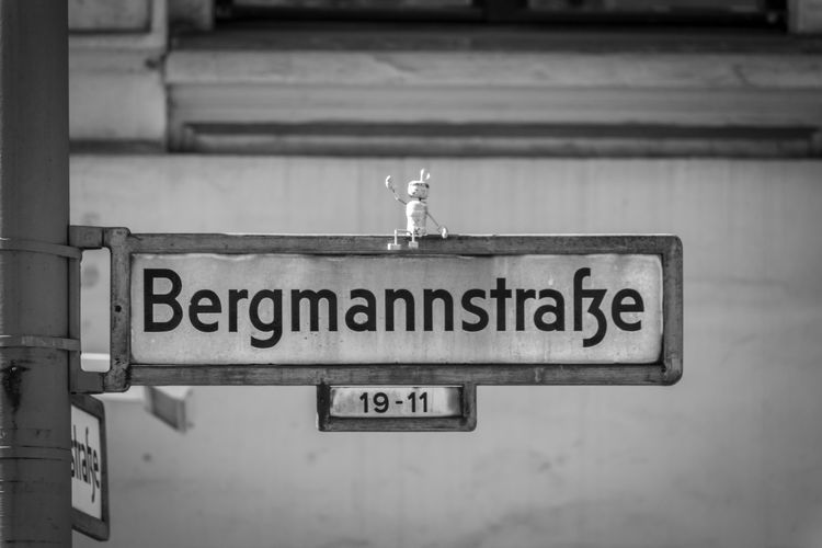 Close-up of information sign wirh street name