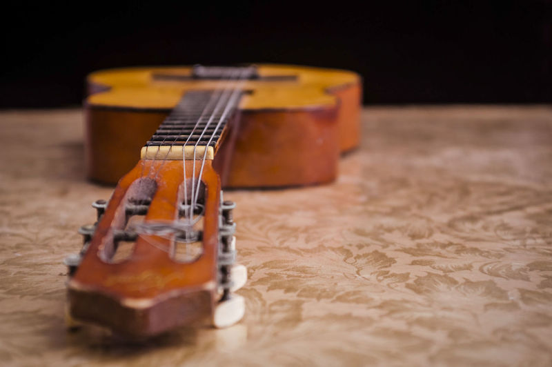 Close-up of acoustic guitar on table