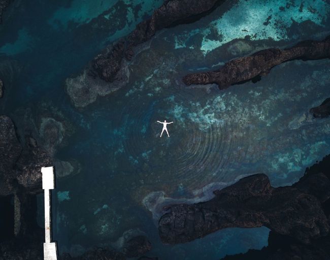 Aerial view of man floating on sea