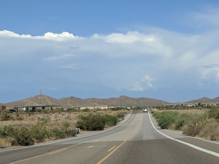 Empty road along arizona desert landscape into the mountains