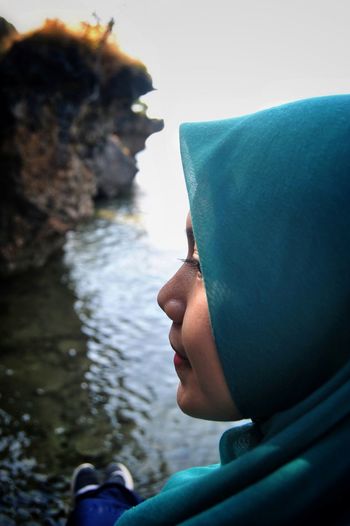 Close-up of woman wearing hijab against sea