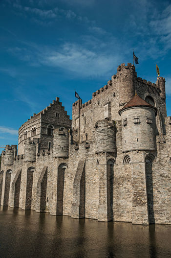 Stone wall and tower of gravensteen castle in ghent. a city full of gothic buildings in belgium.