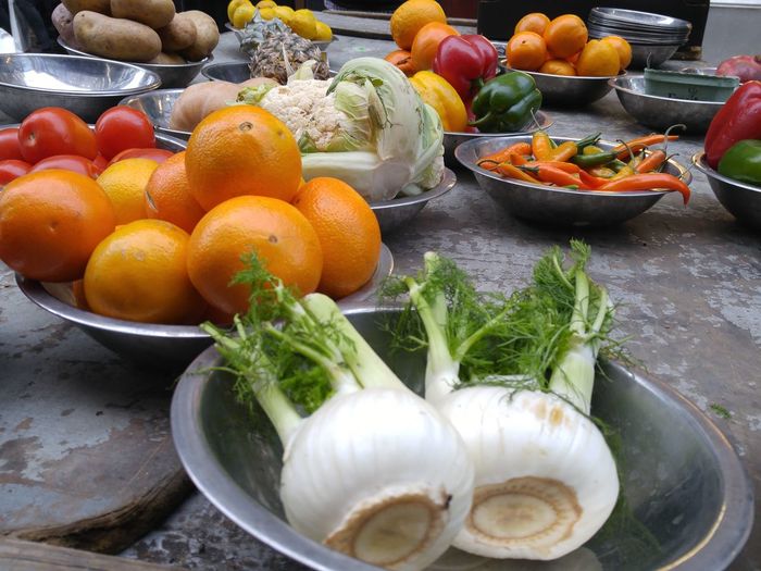 Close-up of vegetables and fruits in bowls for sale