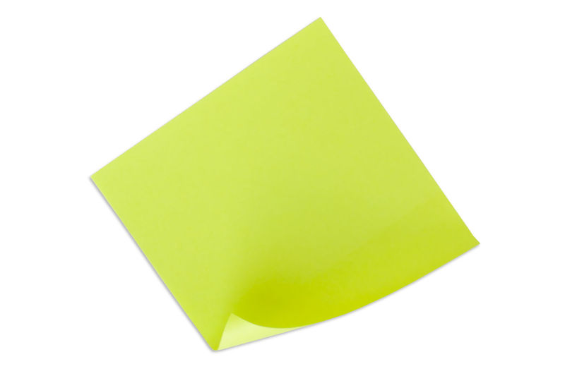 Close-up of yellow paper against white background