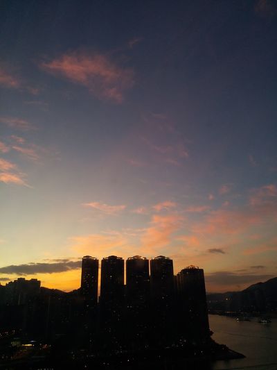 Silhouette buildings against sky during sunset in city