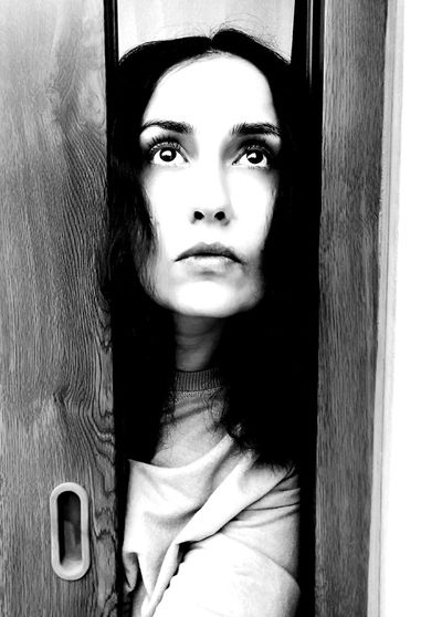 Close-up portrait of woman at home