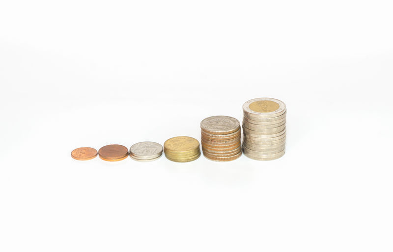 High angle view of coins on white background