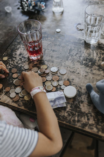Child counting coins on table
