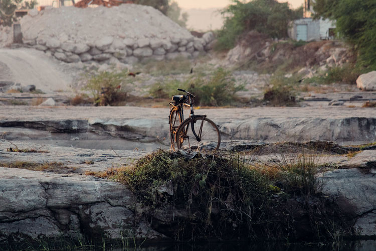 Bicycle on rock at field