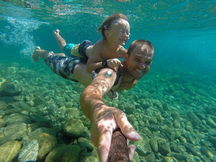 Man with his son swimming underwater
