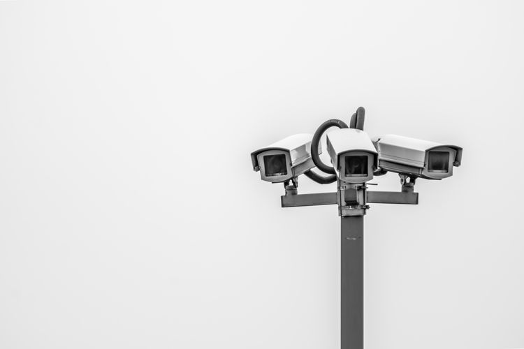 Close-up of security camera against clear sky