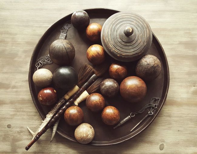 High angle view of wooden balls decoration in container on table