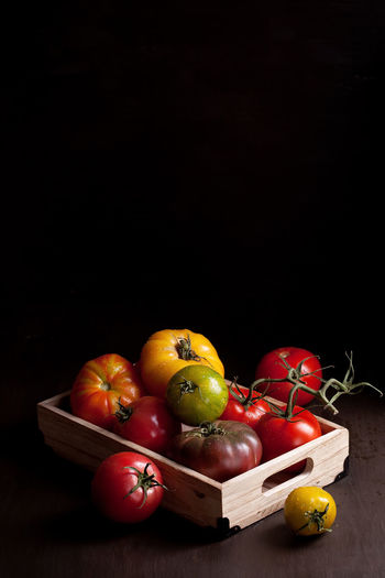 High angle view of fruits on table against black background